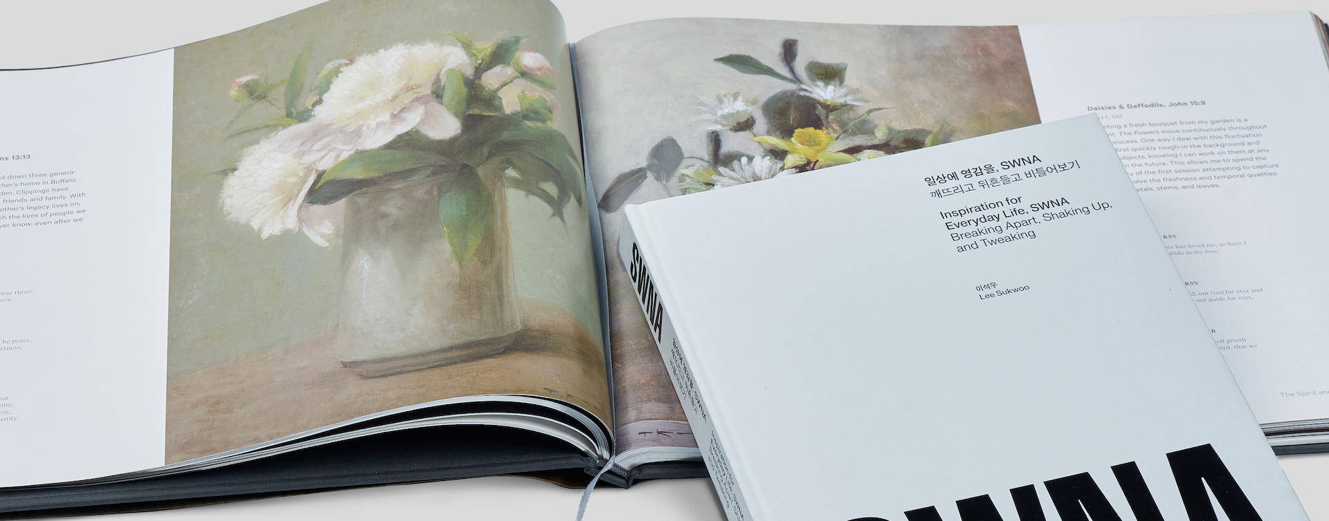 An open hardcover coffee table book with another closed hardcover book elegantly placed on top, showcasing premium finishes and sturdy construction