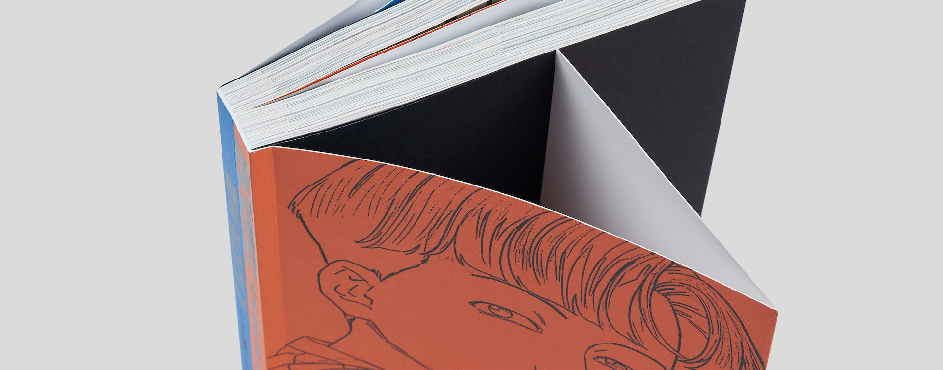 Comic book standing upright with both the front and back flaps visible, emphasizing its premium softcover design