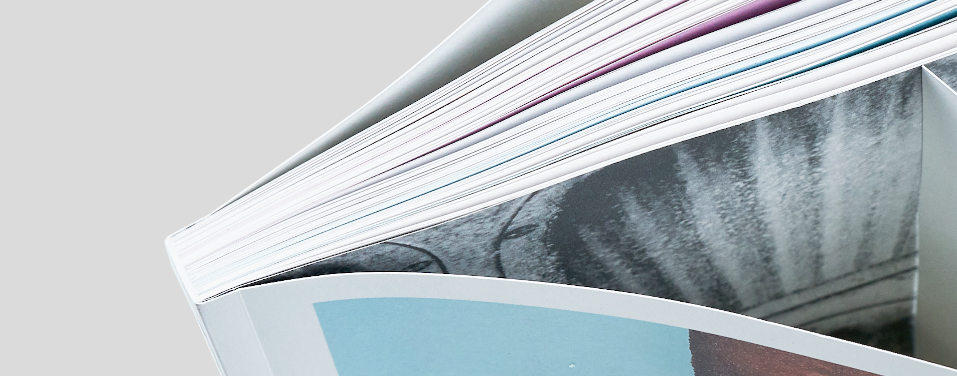 Cookbook standing and slightly opened, with a close-up of the spine to emphasize the quality of the binding