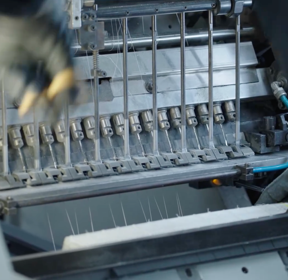 Manual thread trimming during hardcover binding at the inclpress printing facility
