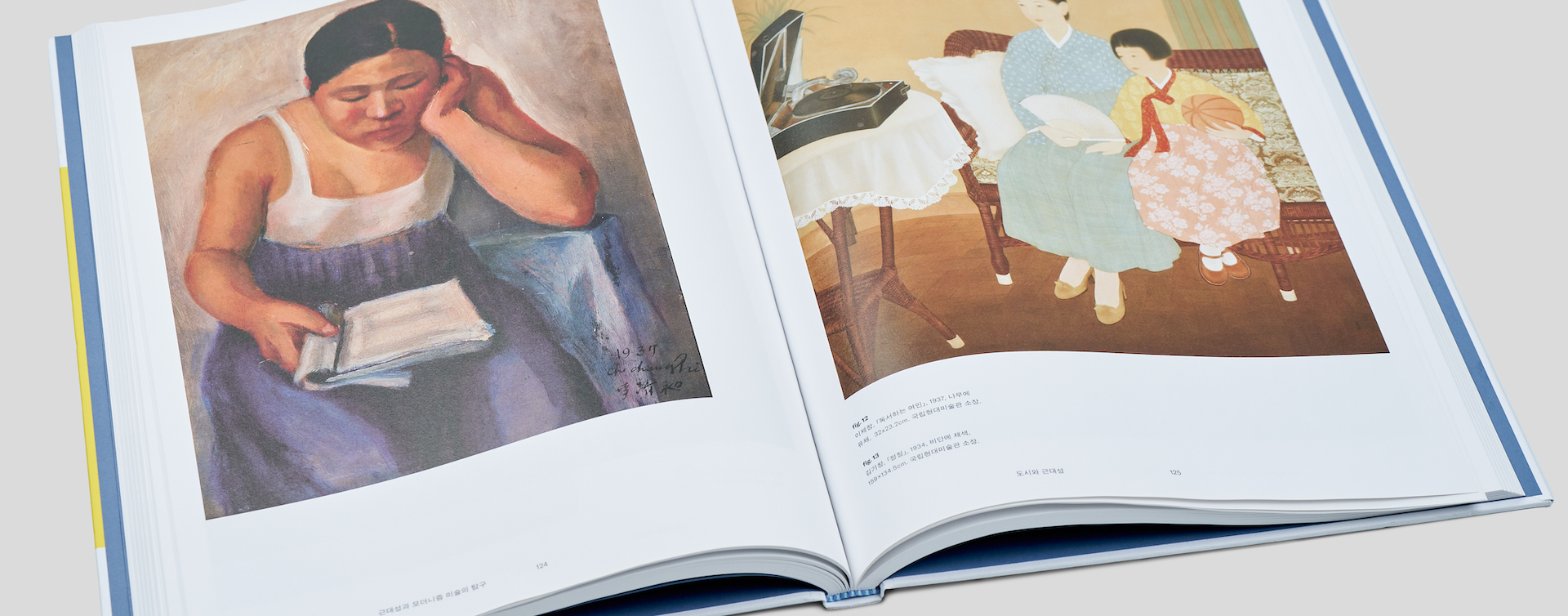 Hardcover art book opened to show high-quality printed interior pages