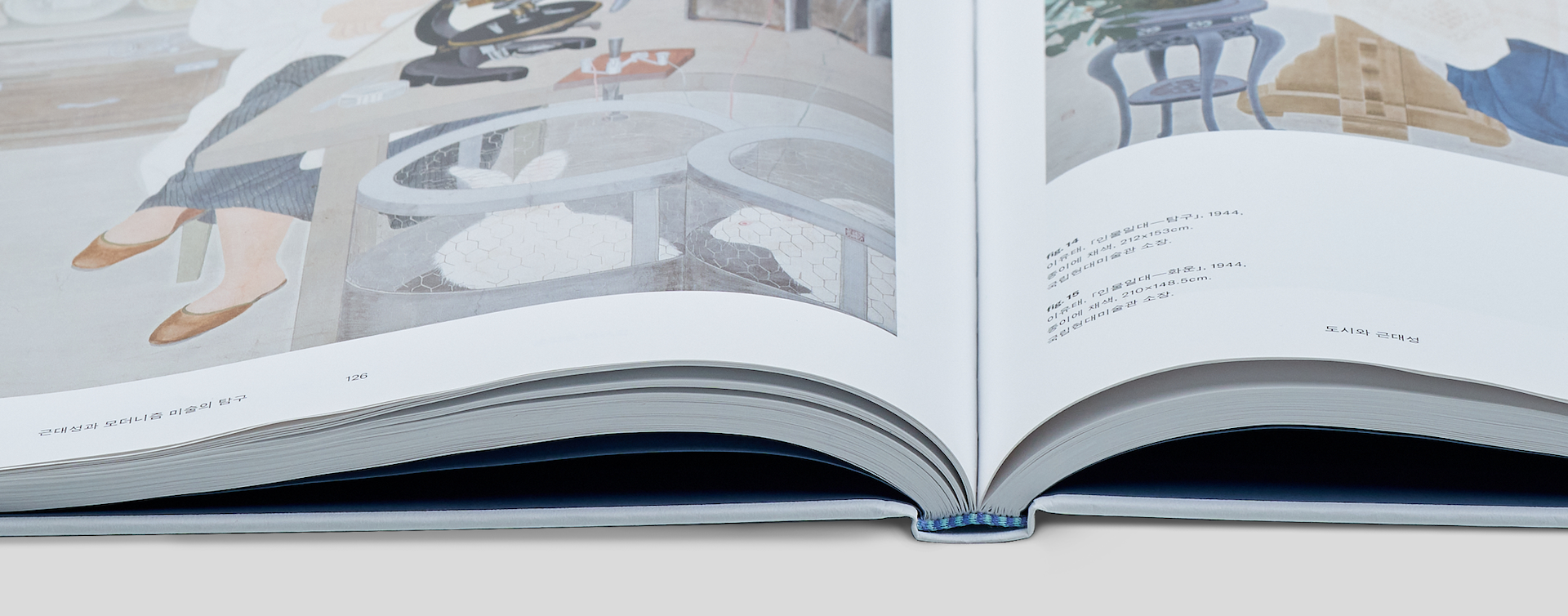 Open hardcover book with close-up of spine area showing clean and precise binding finish