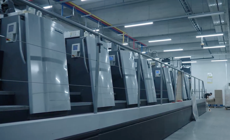 Heidelberg offset press in operation, representing seamless one-stop commercial printing service