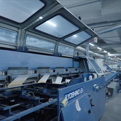 Automatic perfect binding machine used in the final stage of book production at the inclpress facility