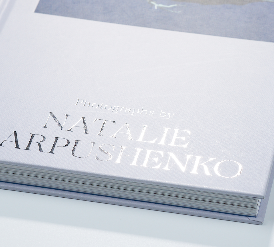 Close-up of foil stamping on a hardcover book cover in silver, showcasing premium finishing at inclpress