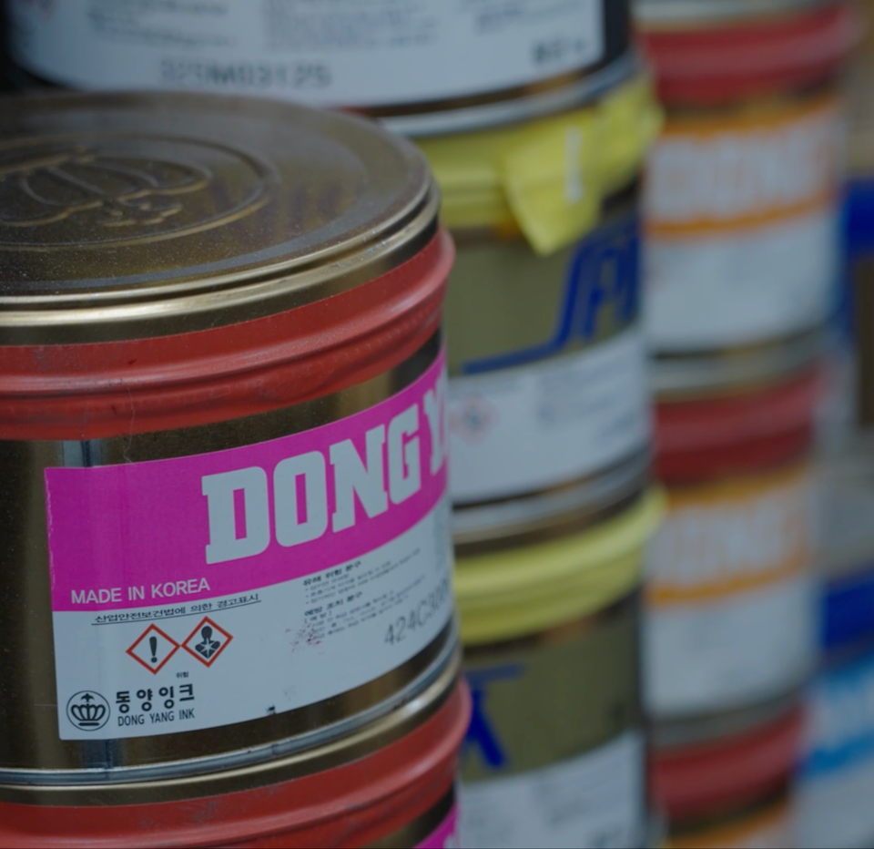 Stacks of Korean-made ink cans used for premium book printing at inclpress