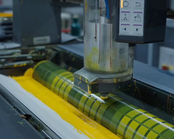 Yellow ink being automatically supplied to Heidelberg press during high-speed book printing at inclpress
