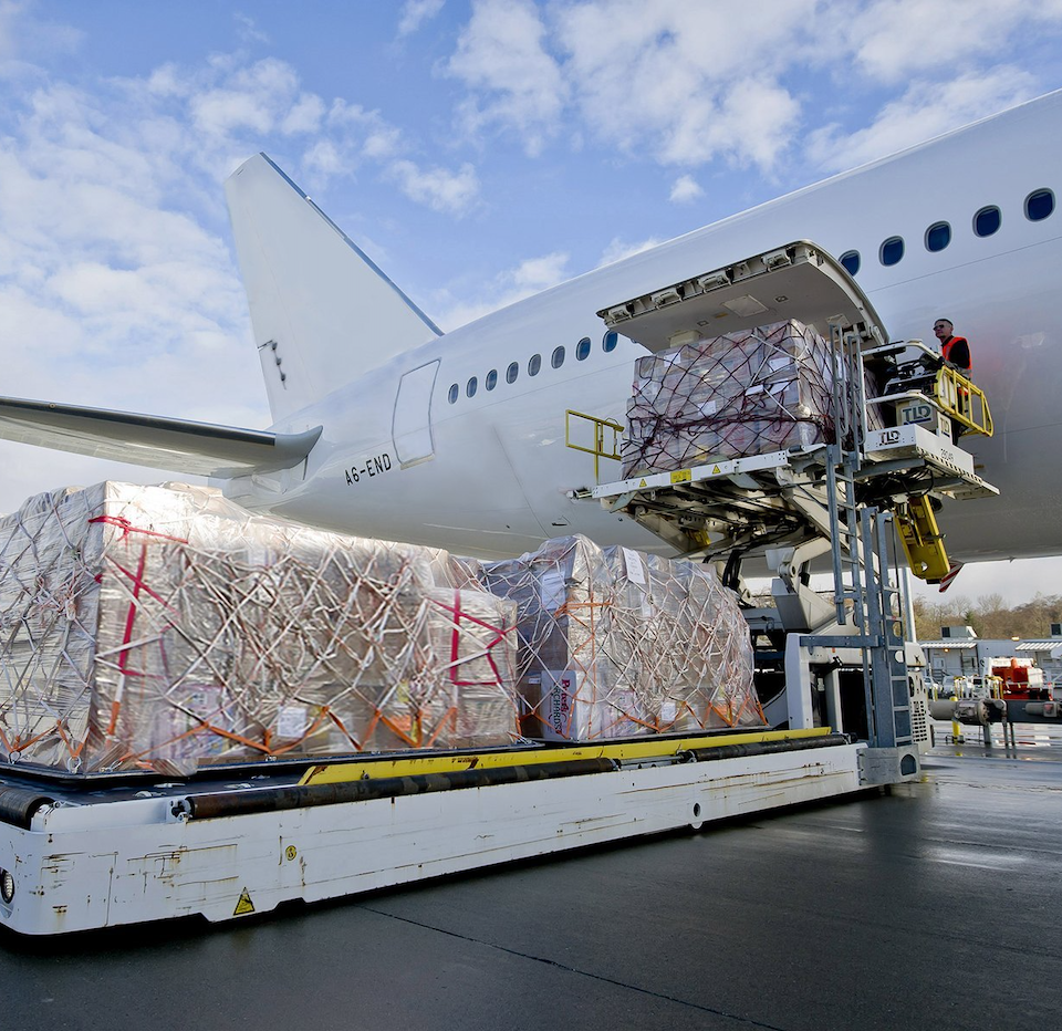 Express air freight service with cargo being loaded onto a plane, representing fast 2-day delivery across the U.S. via FedEx or UPS.